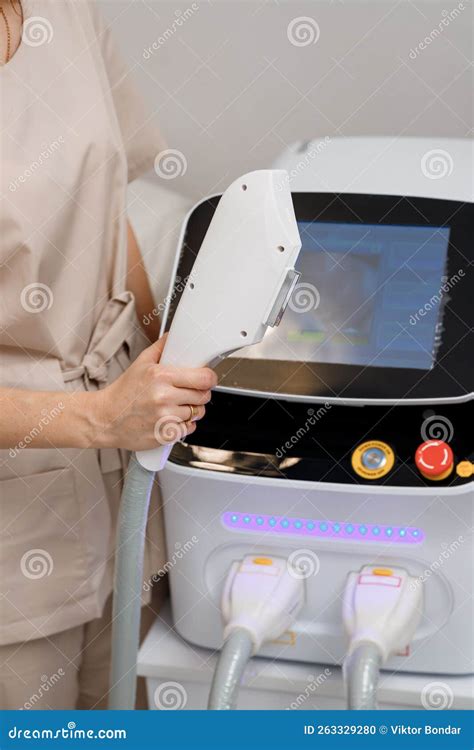 Close Up Of Beautician Hand In Glove Holding Ultrasound Device For Face