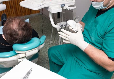 A Dentist Prepares An Implant In The Clinic Editorial Photo Image Of