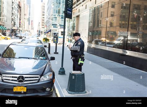 Police Officer Writing A Ticket For Incorrect Parking In New York City