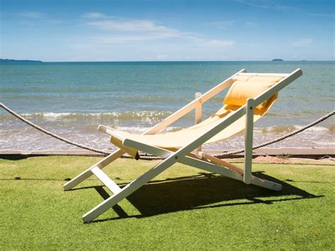 Premium Photo Deck Chairs On Beach Against Sky