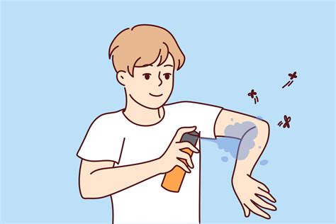 Smiling man applying anti-mosquito spray on arms. Guy use insect ...