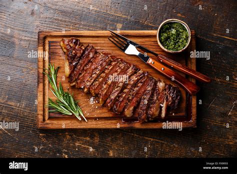 Sliced Grilled Beef Barbecue Striploin Steak With Chimichurri Sauce On