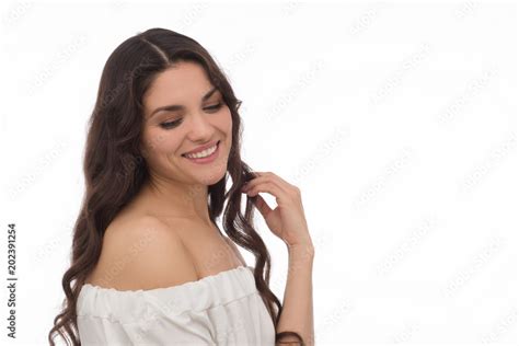 Smiling Brunette Girl With Peal Skin Looking Down In White Studio