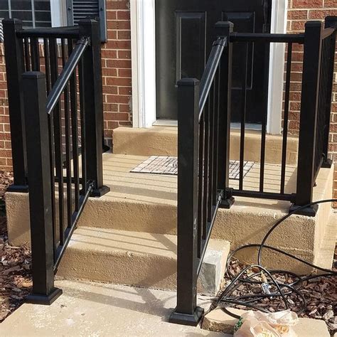 The Front Steps And Railings Of A Brick House With Black Iron Hand Rails On Either Side