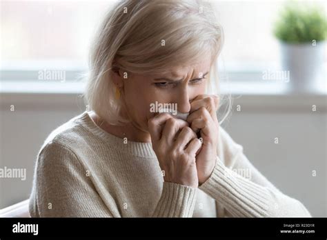 Upset Senior Woman Crying At Home Feeling Lonely And Unneeded Sad Aged