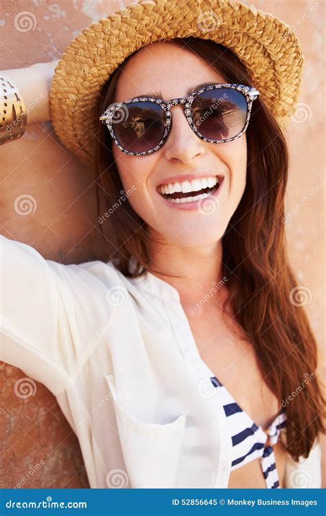 Head And Shoulders Portrait Of Pretty Woman Against Wall Stock Image