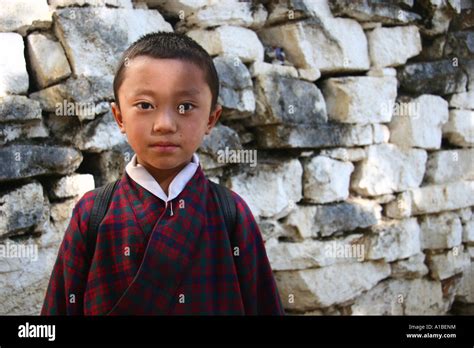 A Young Bhutanese Boy Dressed In A Gho The Traditional Dress For Men