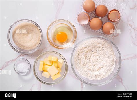 Overhead View Of Basic Raw Baking Ingredients To Include Eggs Sugar Flour Butter Salt On A