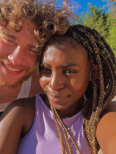 A Man And Woman With Braids On Their Heads Are Posing For The Camera