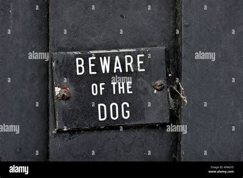 Beware Of The Dog metal warning sign Stock Photo - Alamy