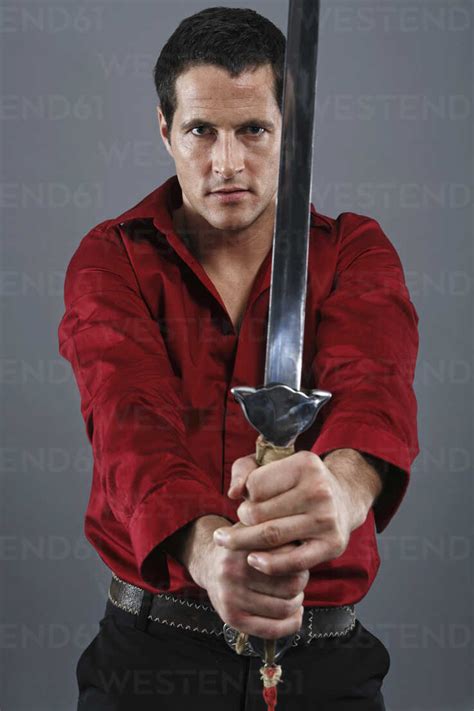 Portrait Of Man Holding Sword Stock Photo