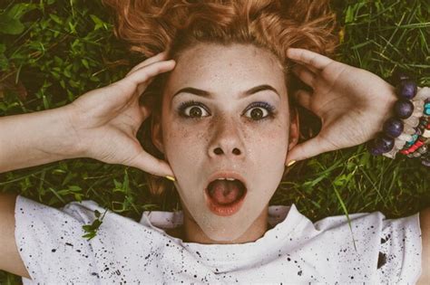 Premium Photo Close Up Portrait Of Shocked Woman Lying On Field