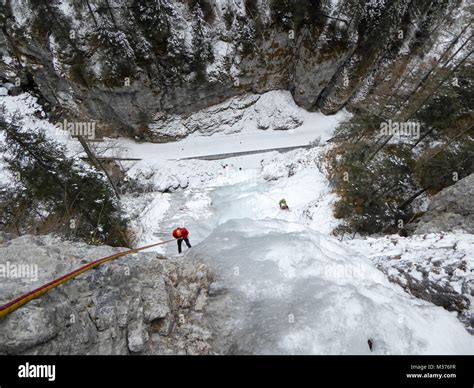 Male Ice Climber On A Steep And Frozen Waterfall In The Serrai Di