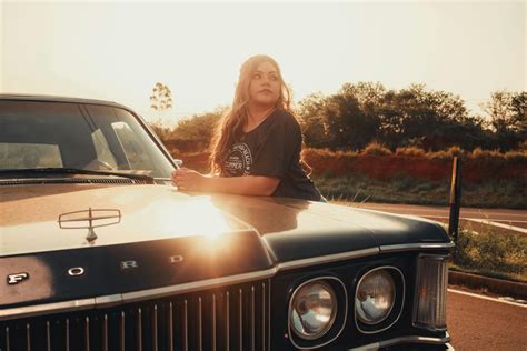 Woman Driving Vintage Car On Road During Daytime · Free Stock Photo