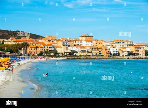 ILE-ROUSSE, FRANCE - SEPTEMBER 22, 2018: People enjoying at the main beach of Ile-Rousse, in ...