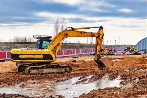 Premium Photo Excavator On Earthworks At Construction Site Backhoe On