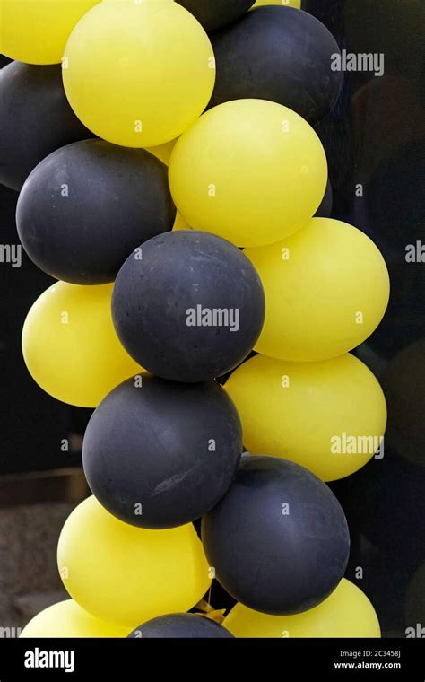 Yellow and black balloons for party decor Stock Photo - Alamy