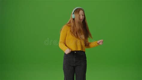 Green Screen Attractive Teenage Girl In Headphones Joyfully Dances