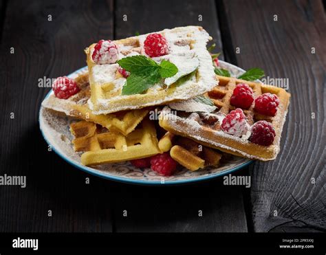 Stack Of Baked Belgian Waffles With Ripe Red Raspberry Sprinkled With