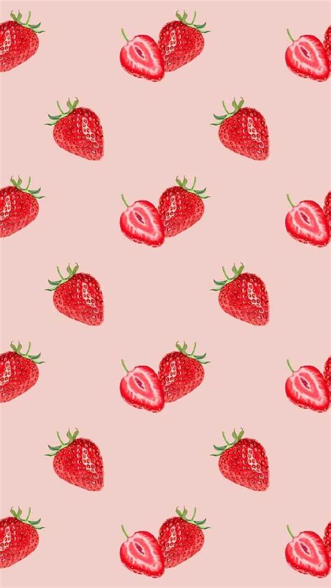 strawberries on a pink background with green leaves