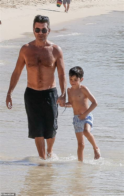 Simon Cowell displays his toned physique as he hits the beach with son ...