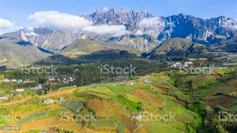 Aerial View Of Kundasang Sabah Landscape With Cabbage Farm And Mount Kinabalu At Far Background