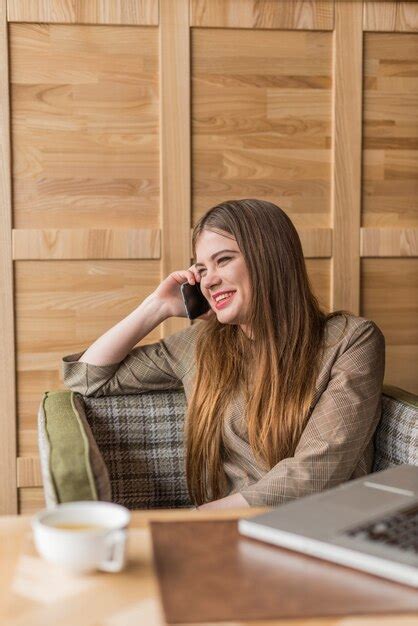 Free Photo Young Woman Laughing While Talking On The Phone