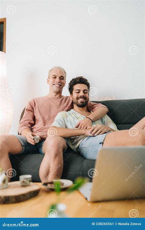 Gay Couple Sitting On Sofa With Laptop Stock Image Image Of Watching Movie 238265561