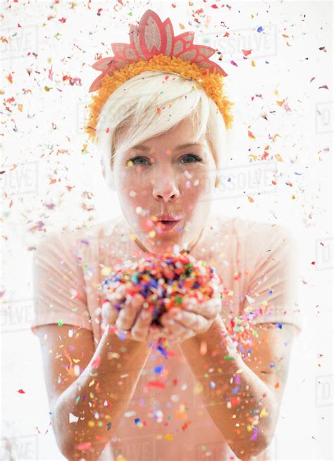 Woman Wearing Tiara Blowing Confetti Stock Photo Dissolve