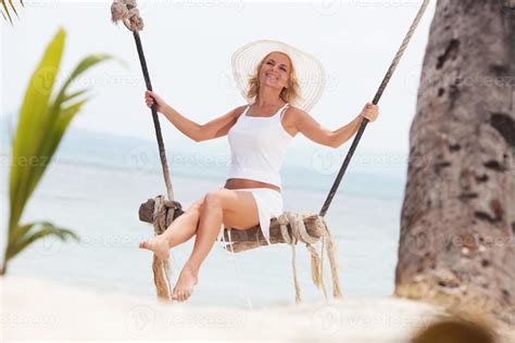 Front view of a woman swinging on the tree swing. 1358410 Stock Photo ...