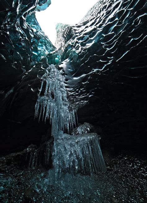 A frozen waterfall inside an ice cave in Breiðamerkurjökull glacier ...