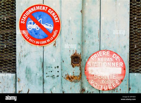 French "No Parking" signs on a wooden garage door Stock Photo - Alamy