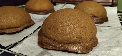 several baked goods sitting on top of a cooling rack in a kitchen ...