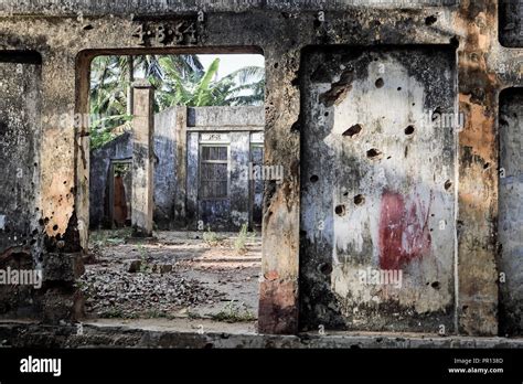 Old concrete building, covered in holes from machine gun fire from Sri ...