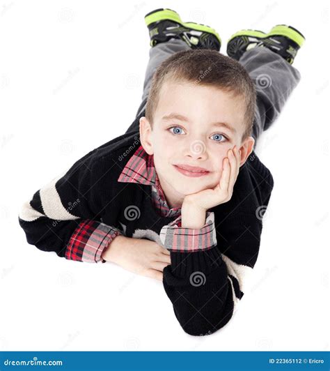 Young Boy Laying on Stomach in Studio Stock Photo - Image of handsome