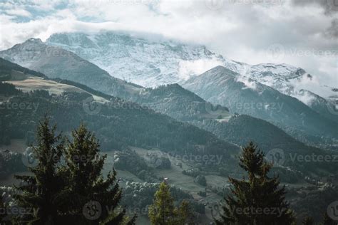 Majestic mountains in the Alps covered with trees and clouds 20487800 ...