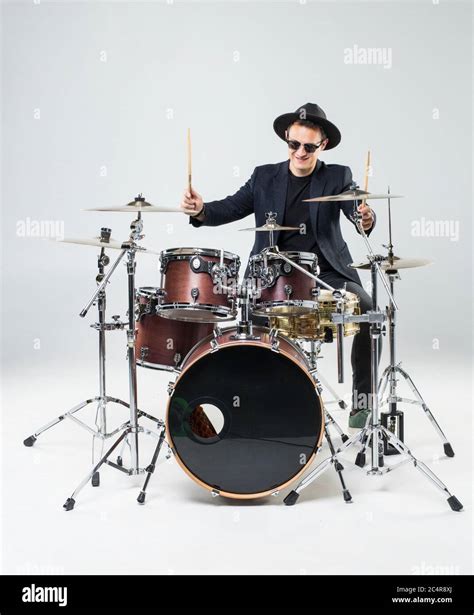 Handsome man behind the drum kit isolated on a white background Stock ...