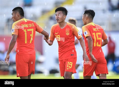 Players of China national football team celebrate after scoring against Kyrgyzstan national ...