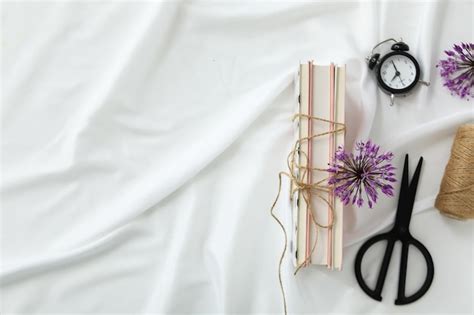 Premium Photo Books Tied With Twine Alarm Clock And Scissors On White