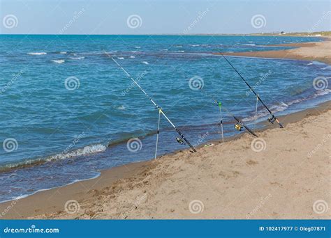 Fishing rods on the beach stock image. Image of holiday - 102417977