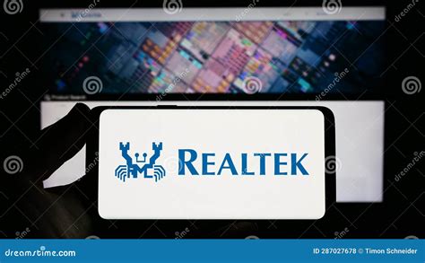 Person Holding Smartphone with Logo of Taiwanese Company Realtek ...