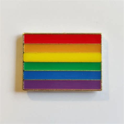 A Rainbow Pin Sitting On Top Of A White Surface