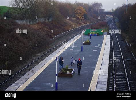 Passengers Wait For A Train At Denton Railway Station In Greater