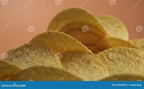 Fried Potato Chips Rotating On An Orange Background Crispy Chips Stock