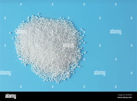 Pellets Of Ammonium Nitrate On Light Blue Background Flat Lay With