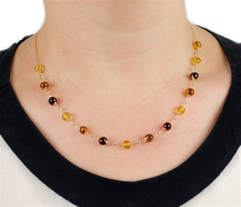 Collana In Oro Giallo Con Centrale Di Ambra E Palline In Oro Sari Gold