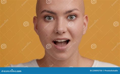 Skin Headed Woman Turning Head To Camera And Smiling Yellow Background