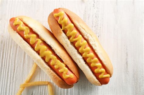 Premium Photo Hot Dogs And Fried Potatoes On Wooden Background