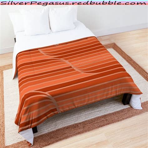 An Orange And White Striped Bed Spread On Top Of A Rug In A Room With