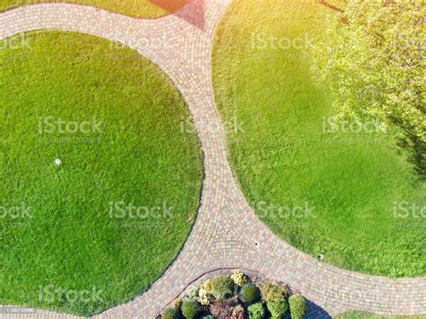 Aerial Drone View Of Backyard Garden With Circle Wath Path Green Grass